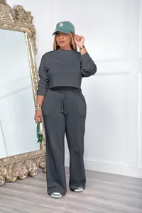 Model wearing dark grey casual sweatshirt and wide-leg trousers tracksuit set indoor