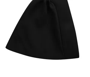 Detailed view of the high-quality black fabric and flared hem on a women's party dress.