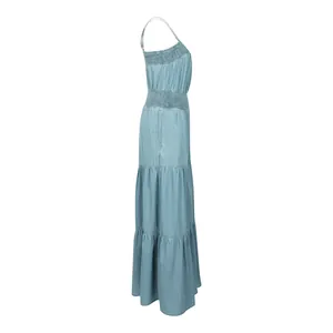 Side view of women's light blue denim camisole jumpsuit featuring wide-leg tiered pants