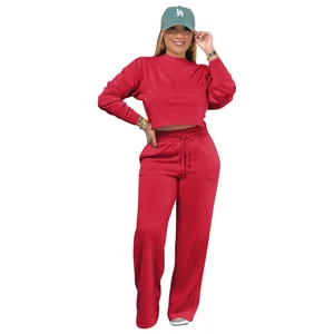 Close-up of red two-piece tracksuit set featuring long sleeve crop top and wide-leg pants