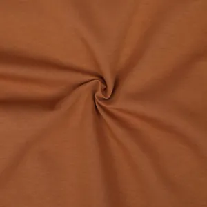 Macro view of soft brown cotton knit fabric texture for autumn winter sports set.