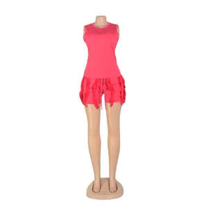 Detail of pink two-piece set featuring tassel fringe tank top and shorts on mannequin.