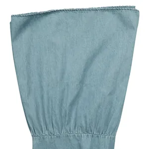 Detailed macro view of light blue denim fabric texture and gathered stitching