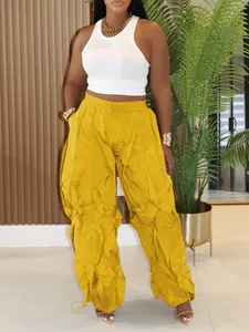 Detail view of mustard yellow ruched wide-leg trousers with drawstring waist for women