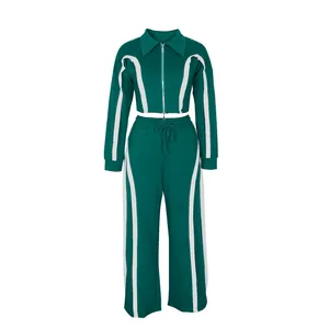Front view of a dark green two-piece sport tracksuit set with white side stripes for women