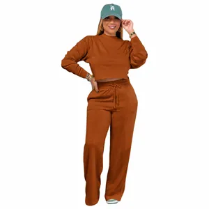 Detailed view of women's two-piece tracksuit featuring crop sweatshirt and wide-leg pants