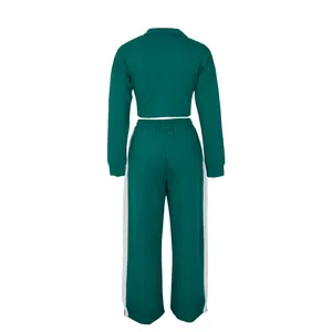 Back view of a dark green two-piece cotton sports set for women including jacket and pants
