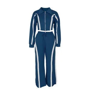 Full view of teal two-piece sports tracksuit for women with white side stripes