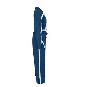 Side view detail of women's blue cotton athletic tracksuit set with white side stripes.