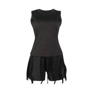 Front view detail of a black two-piece set featuring a tank top and fringe shorts.