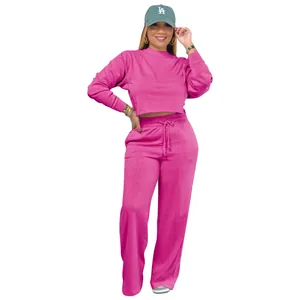 Full body view of a vibrant pink two-piece sweatshirt and matching wide-leg sweatpants set