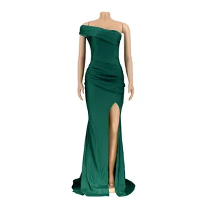 Detail view of a dark green off-the-shoulder evening gown with high slit and ruching.