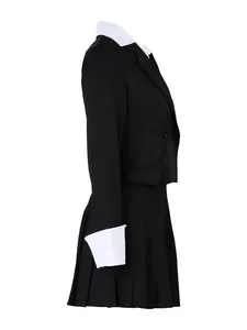 Side profile detail of elegant black blazer and pleated skirt set with white cuffs