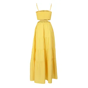 Detail view of yellow tiered boho maxi dress with smocked bodice and sexy waist cutout