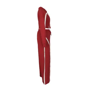 Side view of red two-piece sports set with white stripe detail and wide-leg pants