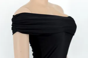 Close-up of elegant black off-the-shoulder pleated detail on formal evening gown for women