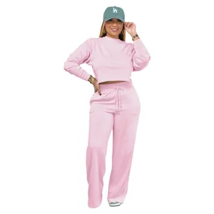 Stylish two-piece pink set featuring a cropped sweatshirt and comfortable wide-leg sweatpants