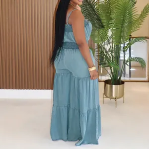 Elegant solid color denim jumpsuit with spaghetti straps and wide-leg tiered design style.