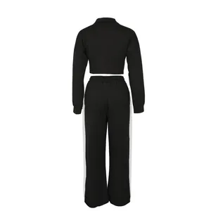 Detailed back view of a black two-piece cotton tracksuit featuring stylish white side stripes