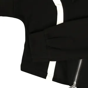 Close-up view of black cotton sports jacket showing white stripe and metal zipper detail.