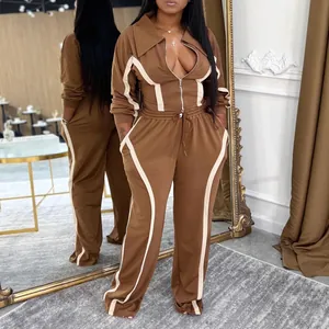 Stylish brown two-piece women's tracksuit with white side stripes for autumn and winter