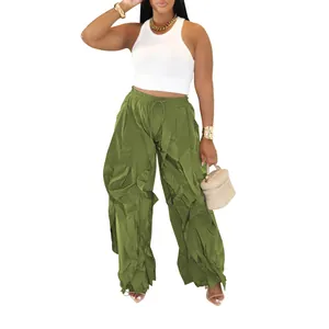 Close-up detail of women's olive green wide-leg trousers featuring intricate ruffled pleats