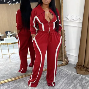 Women's two-piece burgundy tracksuit set featuring white stripes and zip-up jacket