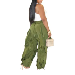 Model wearing olive green wide-leg pleated cargo pants shown from a back side view