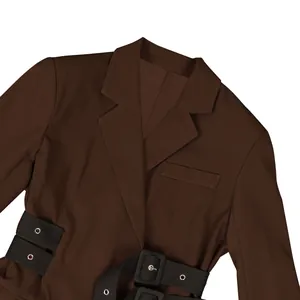 Macro view showing the lapel and waist belt buckle details of a brown tailored women's blazer