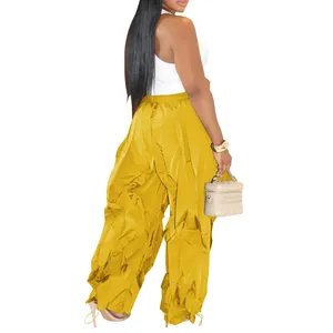 Rear view of yellow wide-leg pleated casual pants for women with loose fit design