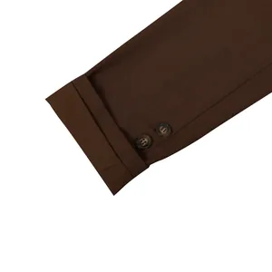 Macro detail view of a deep brown suit jacket sleeve with buttons and stitched cuff