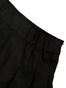 High-quality close-up of a black pleated skirt waistband featuring side zipper detail