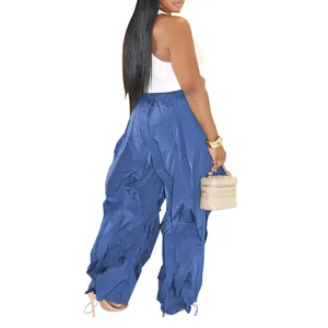 Back view of women's blue wide-leg pleated casual pants with elastic waist.