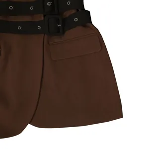 Close-up detail of brown blazer featuring double black buckled belts and a side flap pocket