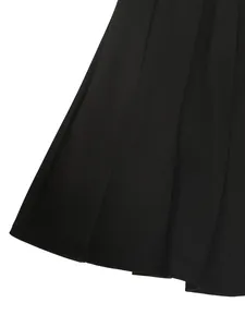 Close-up of black pleated suit skirt showing fabric texture and crisp knife pleats