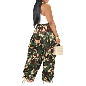 Close-up of camouflage wide-leg cargo pants with ruched side drawstring detailing.