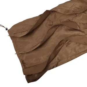 Detail close-up of brown ruffled wide-leg trousers with drawstring and pleated texture
