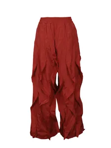 Detailed view of burgundy wide-leg trousers with vertical ruffle pleats and elastic waist