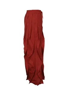 Side view detail of red pleated wide-leg casual trousers with elegant ruffle accents.