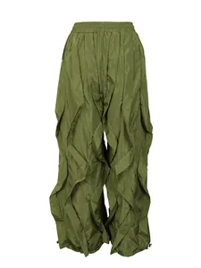 Detailed view of olive green wide-leg trousers with unique vertical pleated ruffles.