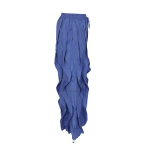 Detail of blue pleated wide-leg pants with unique ruffled patchwork design