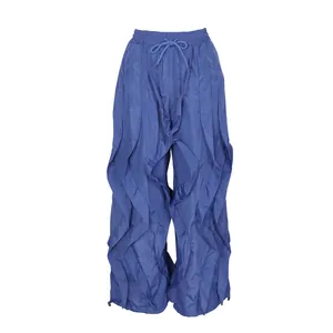 Stylish blue ruffled wide-leg trousers featuring drawstring waist and intricate pleat details
