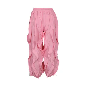 Detailed view of women's pink ruffled wide-leg trousers with layered pleated design.