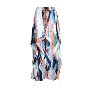 Close-up of abstract watercolor print wide-leg trousers with ruffle detailing and drawstring hem