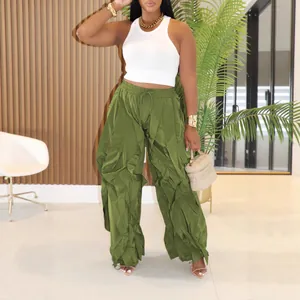 Fashionable women's olive green wide-leg ruffled trousers with a white ribbed tank top