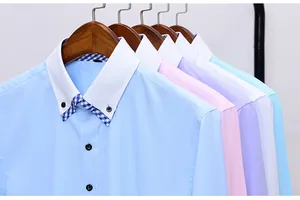 Detail view of colorful men's long-sleeved shirts with double-layer collars on hangers