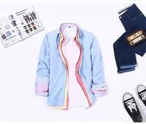 Detailed flat lay showing layered colors and texture of men's cotton Oxford shirts