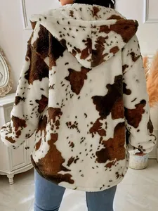 Cozy cow print plush hooded jacket showing the back detail in a stylish home setting.