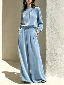 Lichtblauwe retro fluwelen set met top met lange mouwen en wijde broek getoond op model