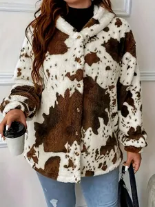 Detailed view of the cow-print fuzzy fleece hooded jacket with button closure.